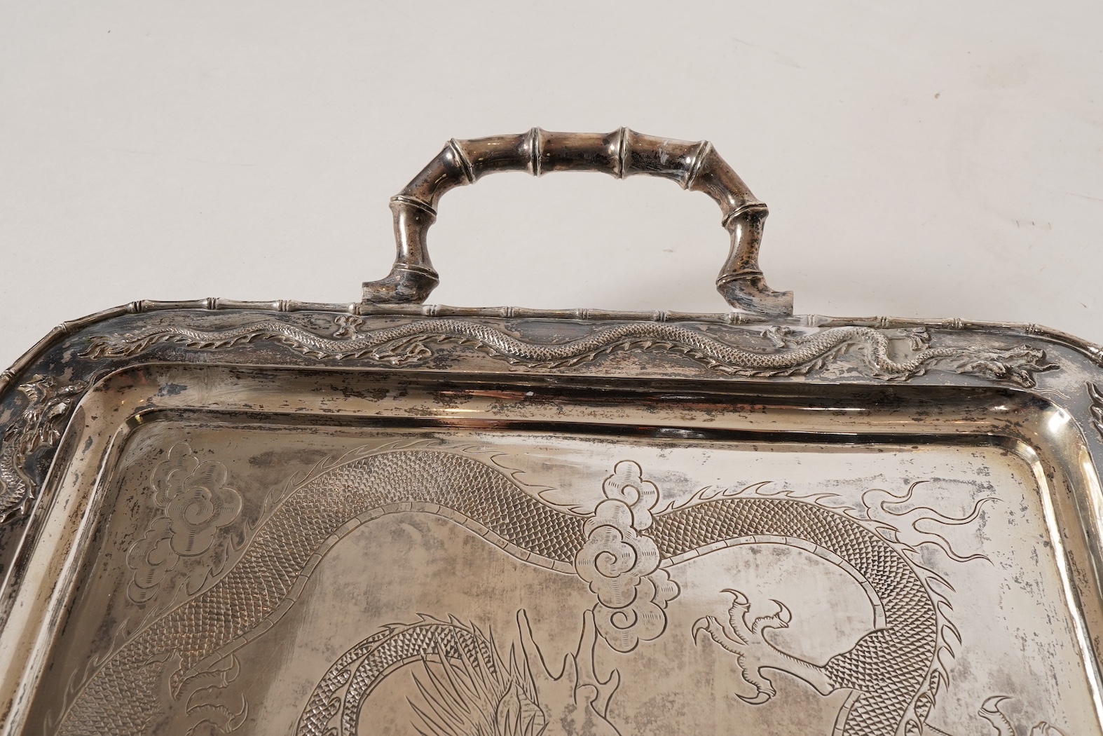 An early 20th century Chinese Export white metal two handled rectangular tea tray, by Luen Wo, Shanghai, with engraved presentation inscription, 'Presented to Captain John Whittle by the undersigned China Navigation Cos.